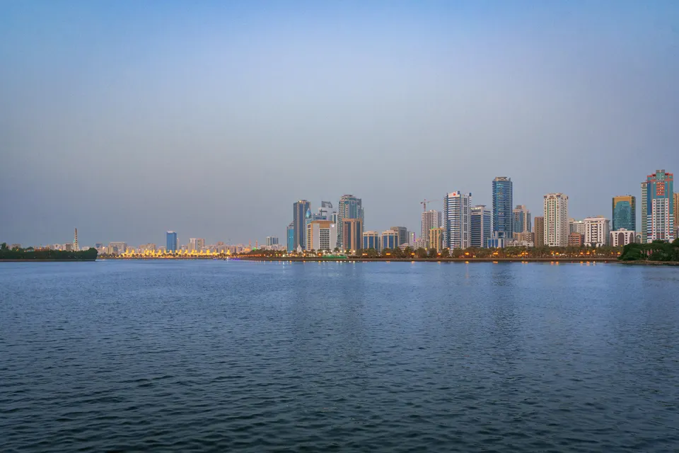 Sharjah waterfront skyline at dusk