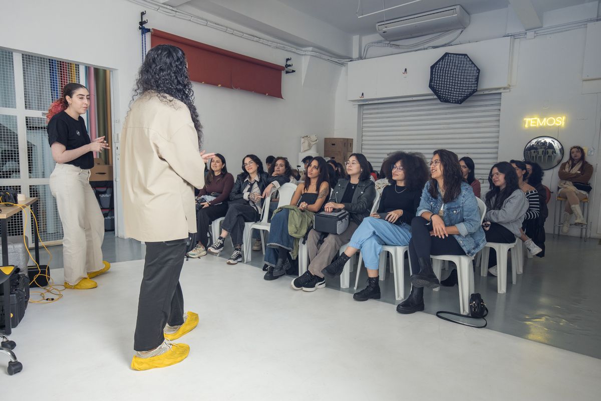 Adults listening to presenters in a creative workshop.